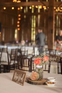 Beautiful barn wedding venue reception with elegant wedding tables, chairs and decor