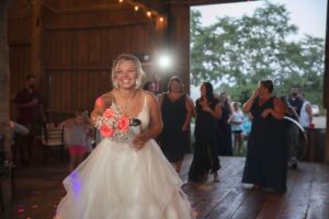 Bride throwing her bouquet to bridesmaids at a wedding reception near Ann Arbor