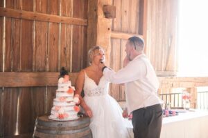 Bride and groom tasting wedding cake at their elegant countryside wedding venue near Ann Arbor