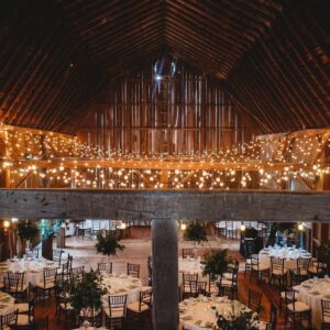 Romantic wedding barn reception with elegant tables and chairs at a barn wedding venue near Ann Arbor Michigan