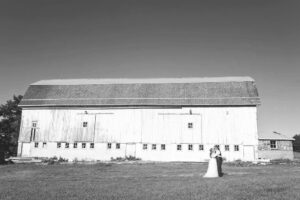 Bride and groom pose for spring wedding photos at a barn wedding venue near Ann Arbor Michigan